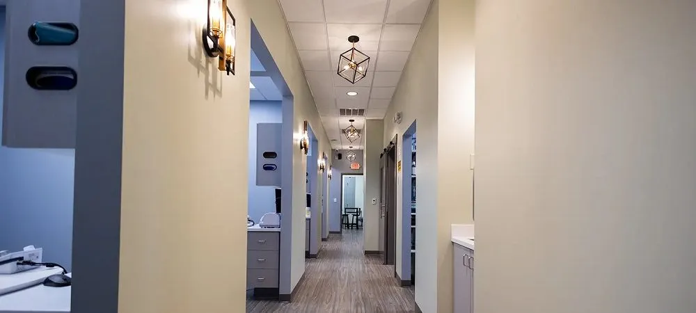 Clean, modern hallway in dental clinic with warm lighting and artwork